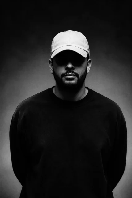 reate a hyper-realistic black and white cinematic portrait based on the uploaded reference image. Keep the exact same vertical composition, centered subject placement, camera angle, portrait framing, distance from camera…